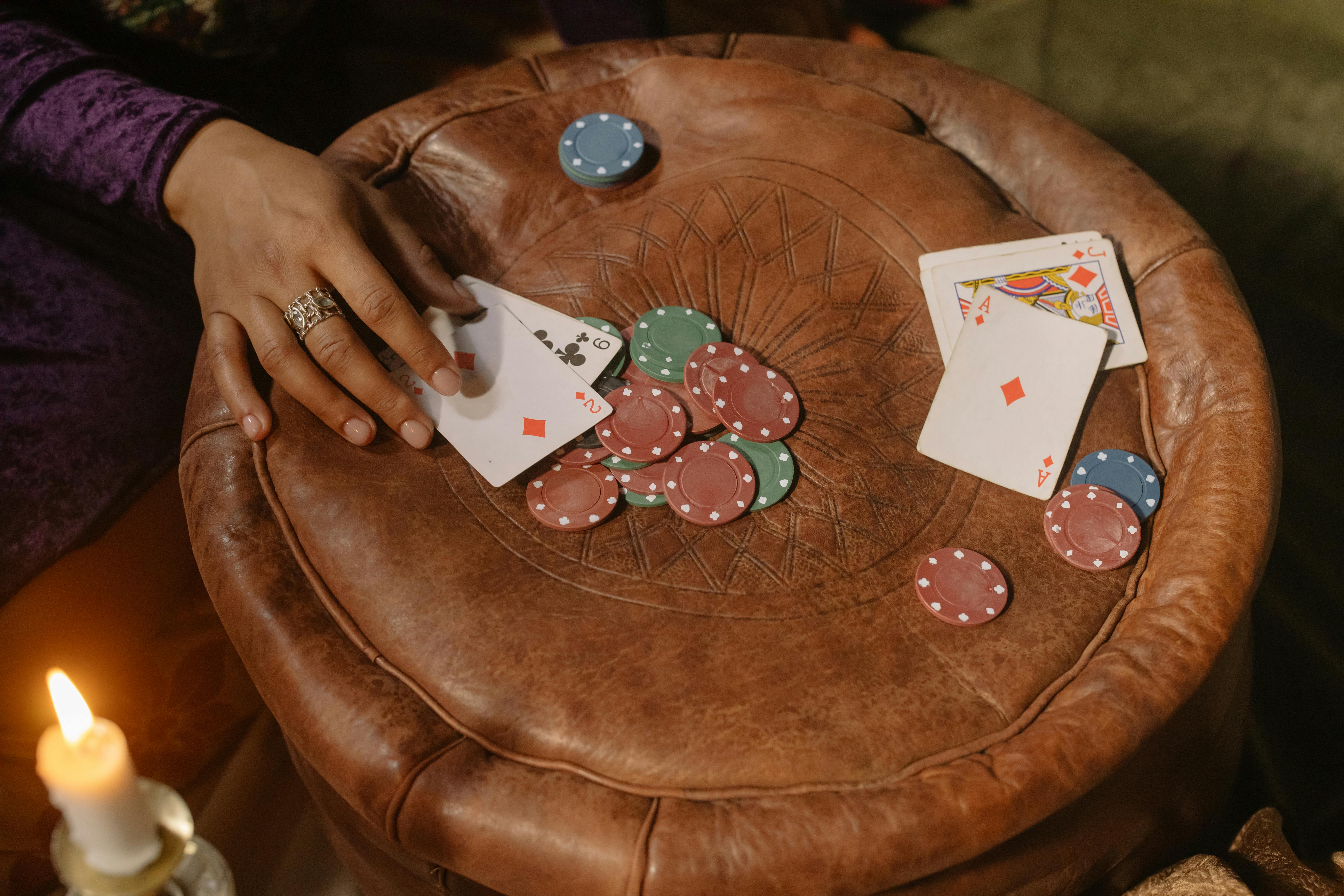 Playing cards and casino chips arranged on a leather table
