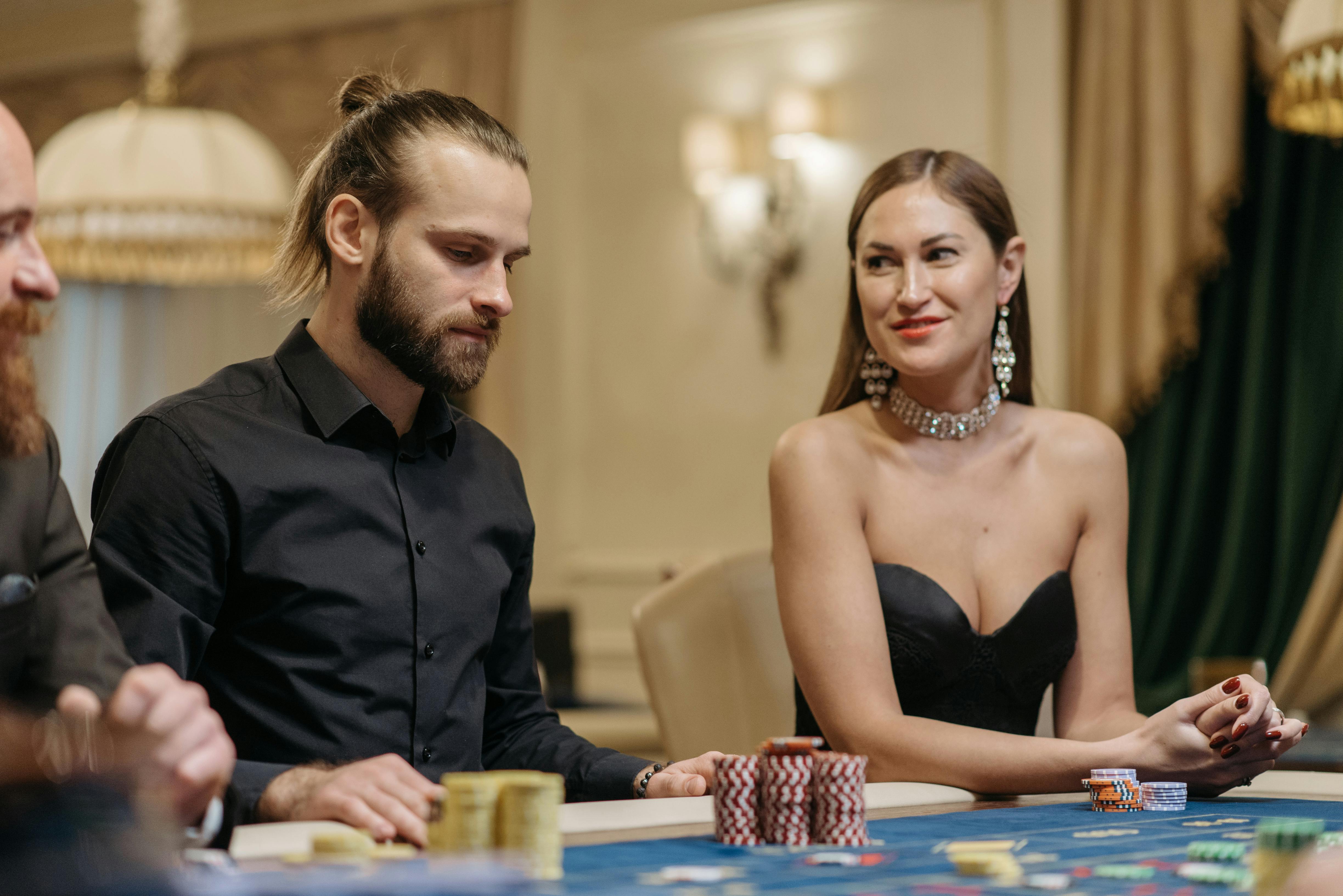 Casino players seated at a gaming table with chips in view
